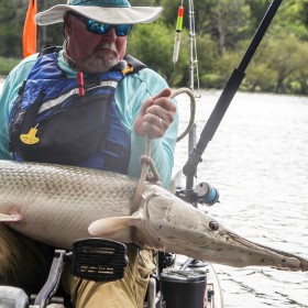 angler out on water ropes in alligator gar after using best alligator gar bait