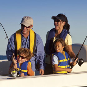 family fishing on a boat