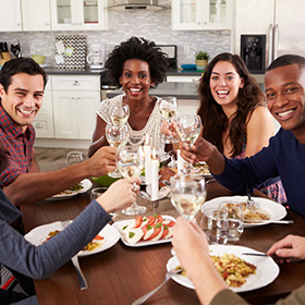 Diverse group of people toasting at dinner